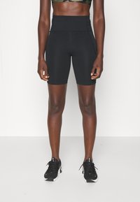 Czarne, wysokowciśnięte sportowe szorty wykonane z elastycznego materiału, cechujące się gładką fakturą i subtelnymi detalami szwów. Idealne do ćwiczeń.