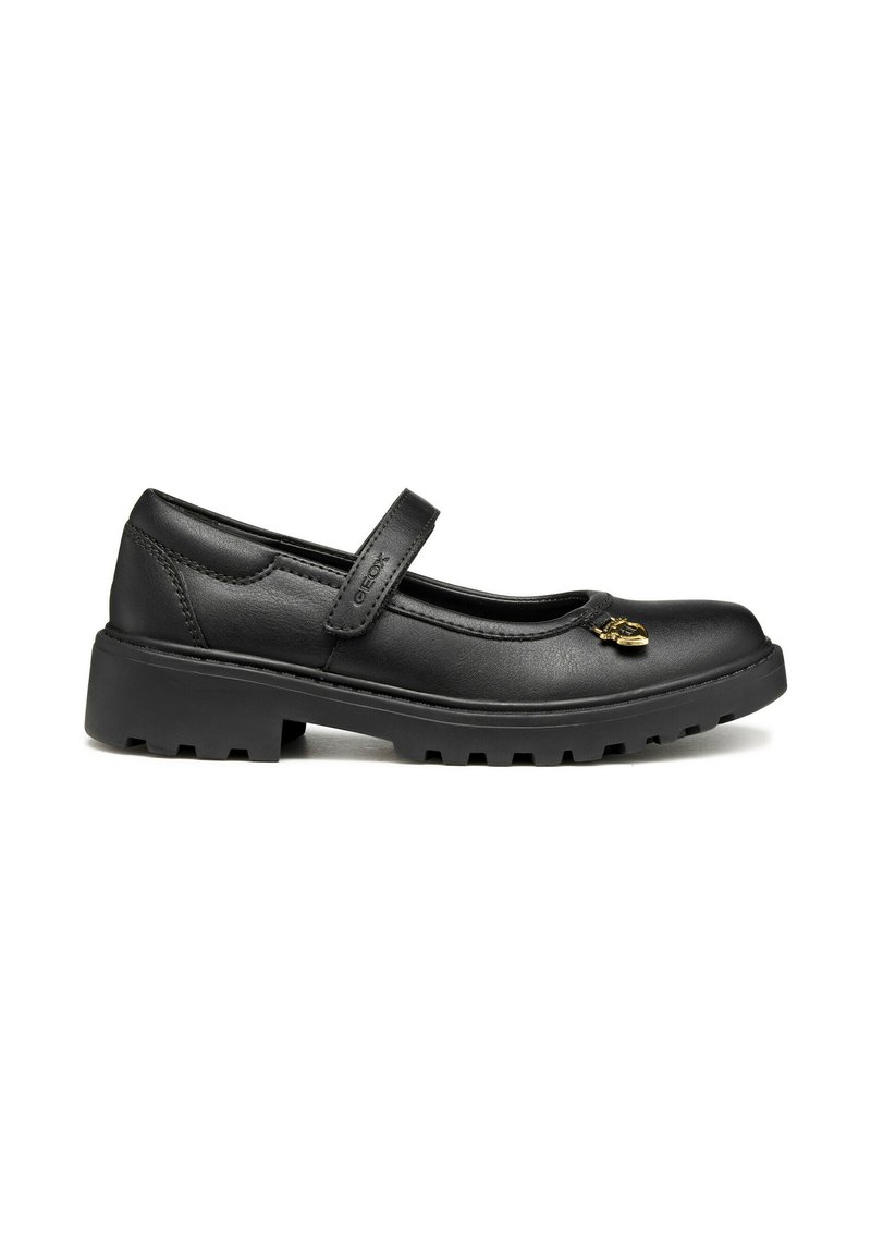 Chaussures Mary Jane en cuir noir avec un bout rond, une sangle réglable et une semelle en caoutchouc texturée, présentant un accent décoratif en or.