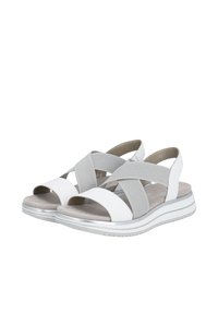 White and gray sandals with cross-strap design, soft texture, and a cushioned sole. Features a silver accent on a thick, white sole.