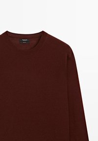Burgundy sweater, 100% wool, crew neck design, long sleeves, smooth texture, ribbed cuffs and neckline, minimalist style with no patterns.