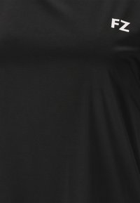 Lähedalt vaadatuna must kangas, mille paremas ülanurgas on väike valge "FZ" logo.