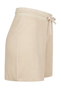 Beige ribbete strikket skjørt med elastisk midje og sidelukking, kne-lengt, som viser stofftekstur og sømdetaljer.