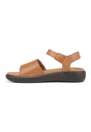 Brown leather sandal with a wide strap across the toe and adjustable ankle strap. Features a cushioned footbed and a black rubber sole.