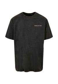 Sort bomulds t-shirt med korte ærmer, en rund halsudskæring og "MERCH•DE" logo i guld på den øverste venstre bryst. Har en slidte effekt.