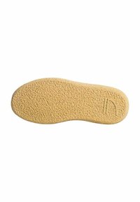 Suola di scarpa in gomma di un colore beige chiaro, con una superficie testurizzata per una migliore aderenza. Forma curvata con un dettagliato design sottile su un lato.