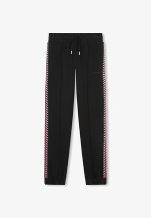 Pantalons de jogging noirs avec une taille à cordon, ornés de rayures en zigzag roses et blanches sur les côtés et de poignets élastiques aux chevilles.