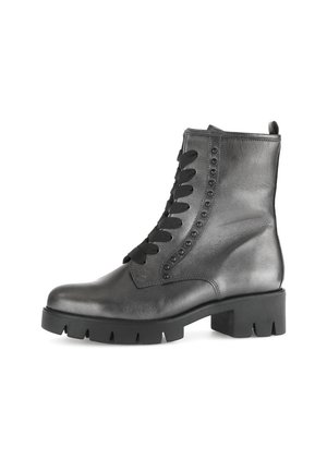 Black leather ankle boots with a round toe, flat rubber sole, and lace-up front featuring decorative studs along the side.