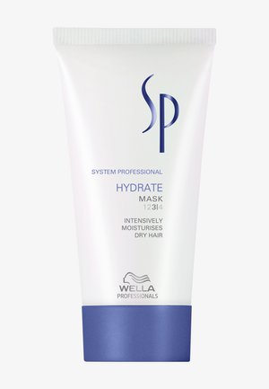 Masque Hydratant Wella SP dans un tube blanc avec un fond bleu. Il présente le logo de la marque, le nom du produit et la description d'utilisation imprimés en bleu.