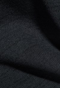 Black fabric with a textured weave, displaying a soft, smooth surface and draped folds. Light reflects subtly, enhancing its depth.