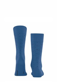 Blaue Socken aus einem glatten Stoff; mit einem Muster aus kleinen schwarzen und Türkis-Punkten; gerippte Bündchen; aufgedrucktes Logo auf der Sohle.