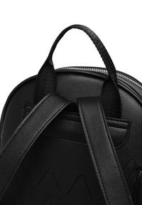 Black backpack featuring smooth leather material, curved shape, sturdy straps, and a top handle; zip closure with textured accents.