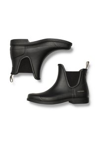 Mustat kumiset nilkkasaappaat, joissa on joustavat sivupaneelit ja vetotappi kantapäällä, erityisesti teksturoidulla pinnalla ja littealla pohjalla.