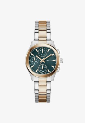 Kahetone metallist käekell kuldsete ja hõbedaste lülidega, tumerohelise valimiga, kolme alamvalikuga ja kuldse tooniga osutite ning tunnimärgistega, kaubamärk Guess.
