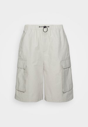Hellbeige Cargo-Shorts mit elastischem Bund, schwarzem Kordelzug und großen Klappentaschen auf beiden Seiten.