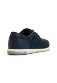 Granatowe sneakersy z siateczkowej cholewki z gładkimi skórzanymi akcentami, okrągłym noskiem, tonującymi sznurowadłami oraz białą gumową podeszwą z teksturowanym gripem.