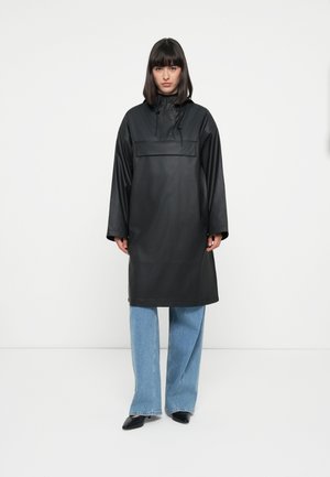 Black waterproof parka with a high neck, front pocket, and drawstring. Features long sleeves and a relaxed, knee-length silhouette.