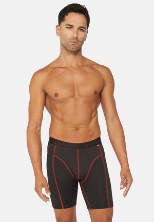 Zwarte boxershorts met rode stiksels, een elastische tailleband met de tekst "Danish Endurance", contrasterende zijpanelen en een aansluitend ontwerp.