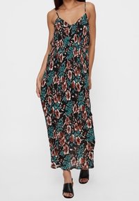 Maximekkot mustana, jossa on suuri kukkakuosi punaisena, valkoisena ja tealina. Varustettu säädettävillä spagettiolkaimilla ja virtaavalla siluetilla.