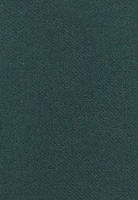 Textiel in diep teal, met een gladde textuur en een uniform breipatroon, geschikt voor kleding of bekledingsdoeleinden.