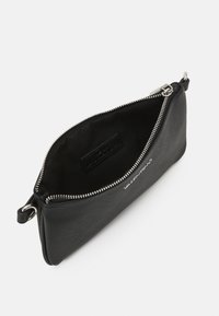 Borsa a pochette in pelle nera con superficie Texturizzata, chiusura con zip argentata e logo visibile sul lato. L'interno è foderato e di colore scuro.