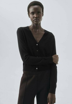 Black cardigan with a deep V-neck, long sleeves, front button closure, and a fitted silhouette. Made from a soft, textured fabric.
