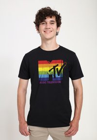 Black t-shirt featuring a multicolored rainbow MTV logo with "MUSIC TELEVISION" text below. Short sleeves, crew neck, cotton material.