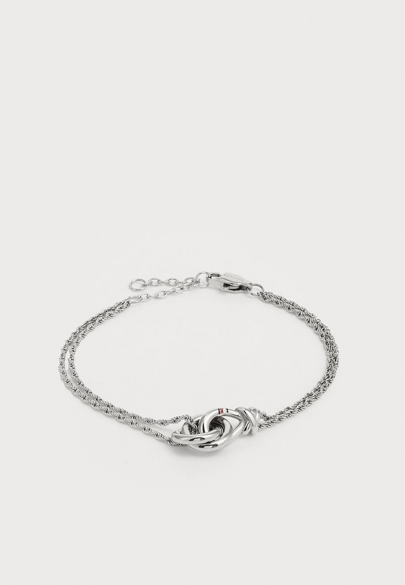 Silver twisted chain bracelet featuring a central knot design with a red accent. Adjustable length with a secure clasp closure.