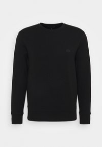 Svart långärmad sweatshirt med rund halsringning och ribbstickade mudd och fåll, med en liten tonad logotyp på vänster bröst.