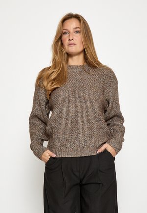 Pull en maille marron avec un motif texturé, encolure ronde, manches trois-quarts, et bords côtelés au niveau des poignets et de l'ourlet. Porté avec un pantalon noir.