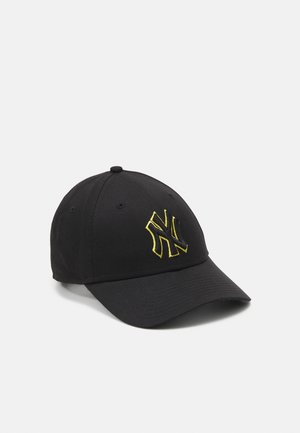 Black baseball cap with curved brim, featuring yellow embroidered "NY" logo on the front and a textured fabric finish.