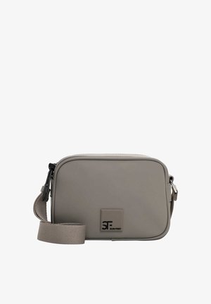 Grey crossbody bag with a smooth texture, rectangular shape, zip closure, and adjustable strap. Features a logo on the front.