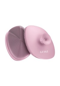 Spazzola per capelli rosa con un design a setole spiralate e testurizzate e un manico circolare liscio. Presenta un marchio prominente su un lato.