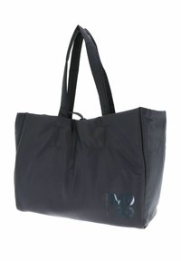 Sac fourre-tout noir en nylon rembourré avec deux longues poignées, présentant des détails piqués et un logo "MD20" brillant sur le côté.