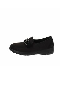 Scarpa nera slip-on con tomaia in tessuto liscio, suola piatta in gomma e un accentuato dettaglio decorativo a forma di fibbia. Design elegante e slanciato.