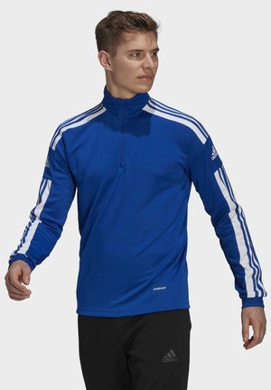 Koninklijkblauw sporttop met witte strepen langs de mouwen, hoge kraag en een kwart-rits aan de voorkant. Bevat het "AEROREADY"-logo aan de zoom.