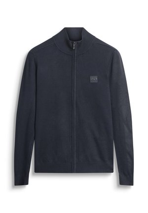 Navy zip-up sweater in soft knit fabric, featuring a stand-up collar and ribbed cuffs, adorned with a logo patch on the chest.