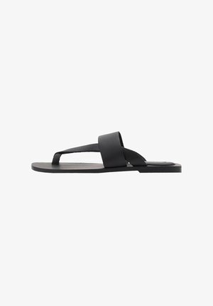 Black flip-flop sandal featuring a flat sole, wide straps, and a minimalist design. Made from flexible material with a smooth texture.