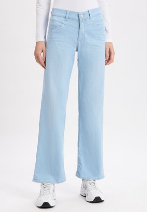 Light blue wide-leg jeans made of denim, featuring a button closure, front pockets, and a smooth texture. Styled with white sneakers.