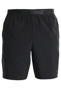 Shorts de sport noirs avec une ceinture élastique présentant un logo Nike répété en gris foncé.