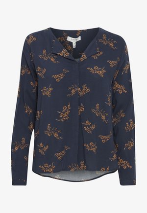 Blusa navy con maniche lunghe, stampa floreale in ruggine e crema. Presenta un colletto e un orlo leggermente più corto sul davanti. Realizzata in tessuto leggero.