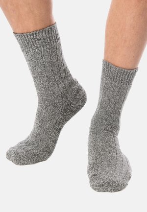 Gray knitted socks with ribbed cuffs, featuring a textured pattern. The fabric appears thick and cozy, ideal for warmth and comfort.