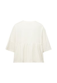 Chemise ample à manches courtes couleur crème avec un détail de tissu froncé sous la ligne des épaules, vue de dos.