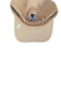 Beige baseball cap with a curved brim, cotton material, embroidered accents, and a metallic sticker featuring a baseball design on the side.