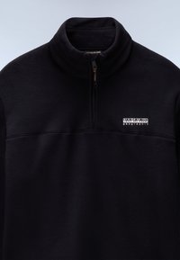 Black fleece pullover with a high collar and short zipper. Features a horizontal seam and a small white logo on the left chest.