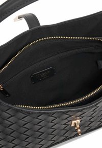 Black woven leather handbag interior featuring a soft black lining, one zippered pocket with gold hardware, and a brand label.