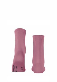 Pink ribbed socks with a seamless toe design, featuring reinforced heels and a logo printed at the base. Lightweight and elastic fabric.