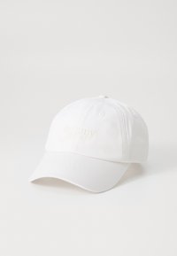 Hvid bomulds baseballkasket med en buet skygge og broderet "tommy jeans" logo i lys creme på fronten. Strukturér overflade.