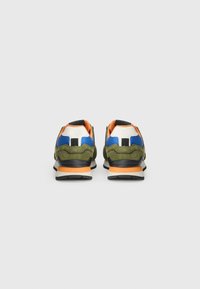 Sneakers with a green upper, black sole, orange accents, and blue details. Textured fabric with a wavy design and padded collar.