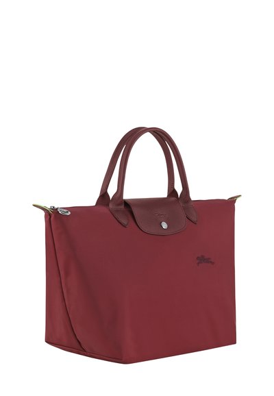 Red nylon tote bag with leather accents, two handles, and a top snap closure. Features a subtle logo and smooth texture.