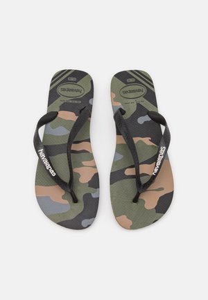 Paire de tongs noires à bride avec semelles camouflage vert, marron et gris et logo blanc "Havaianas" sur les brides.